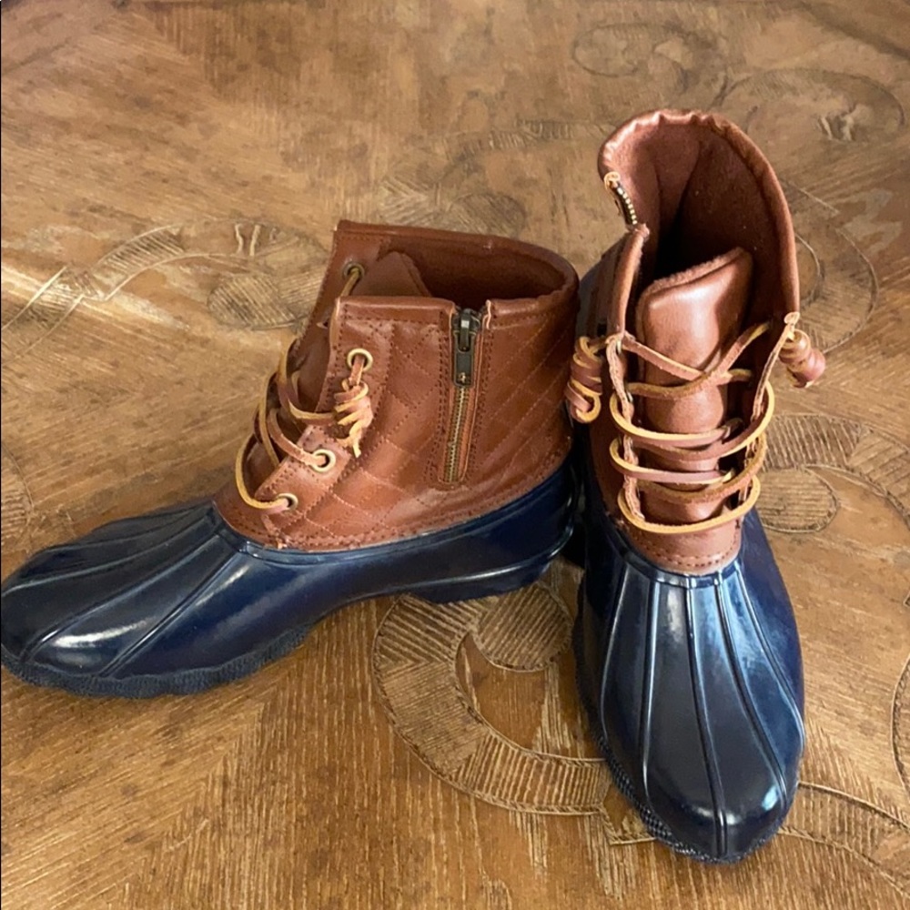 Duck boots, worn lightly